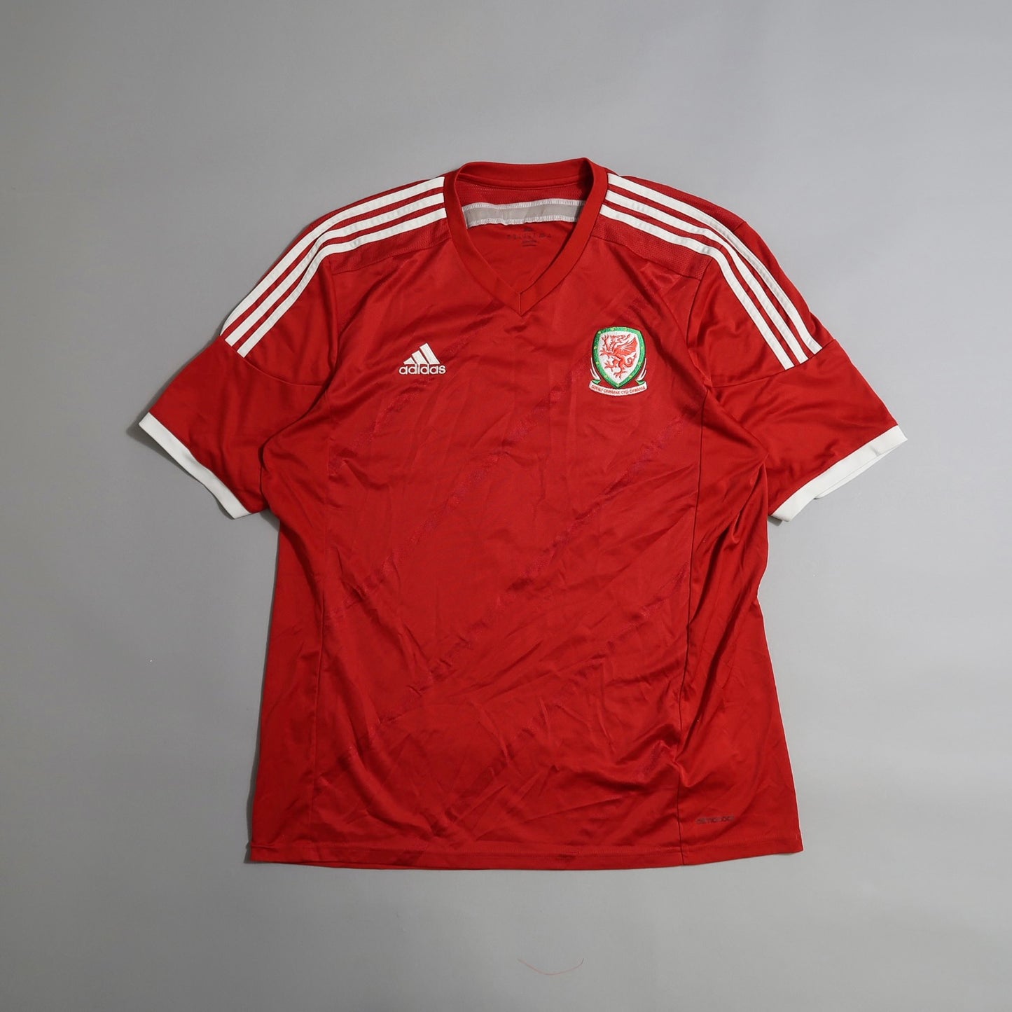 Red soccer jersey with Wales emblem and Adidas logo.