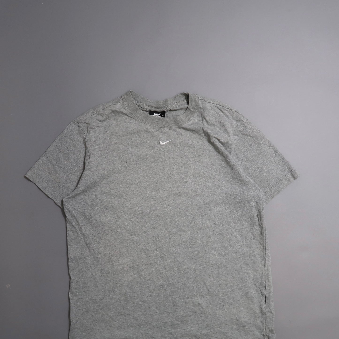 Gray Nike T-shirt on a gray background.