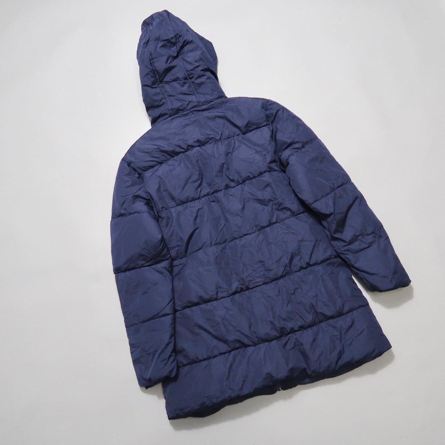 Blue hooded puffer jacket displayed on a flat surface.