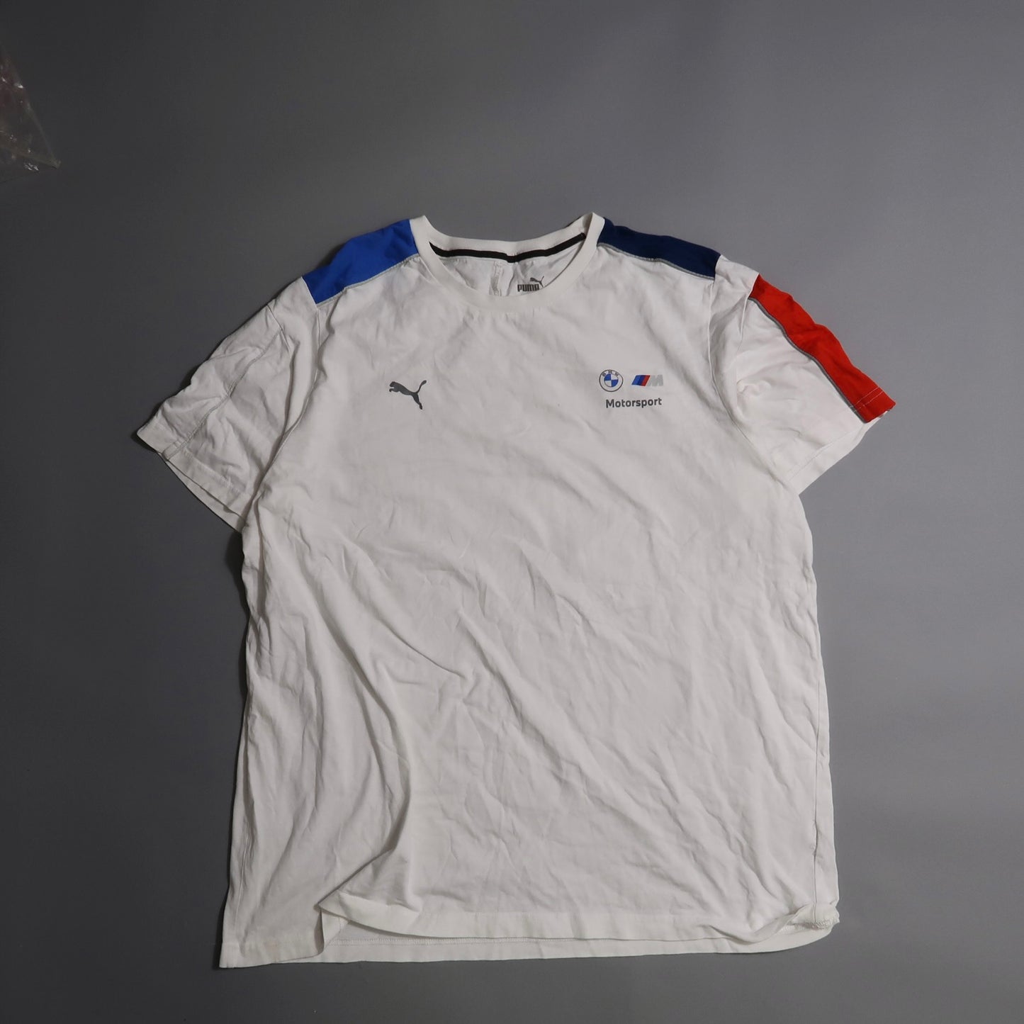 White BMW Motorsport T-shirt with blue and red shoulder accents.