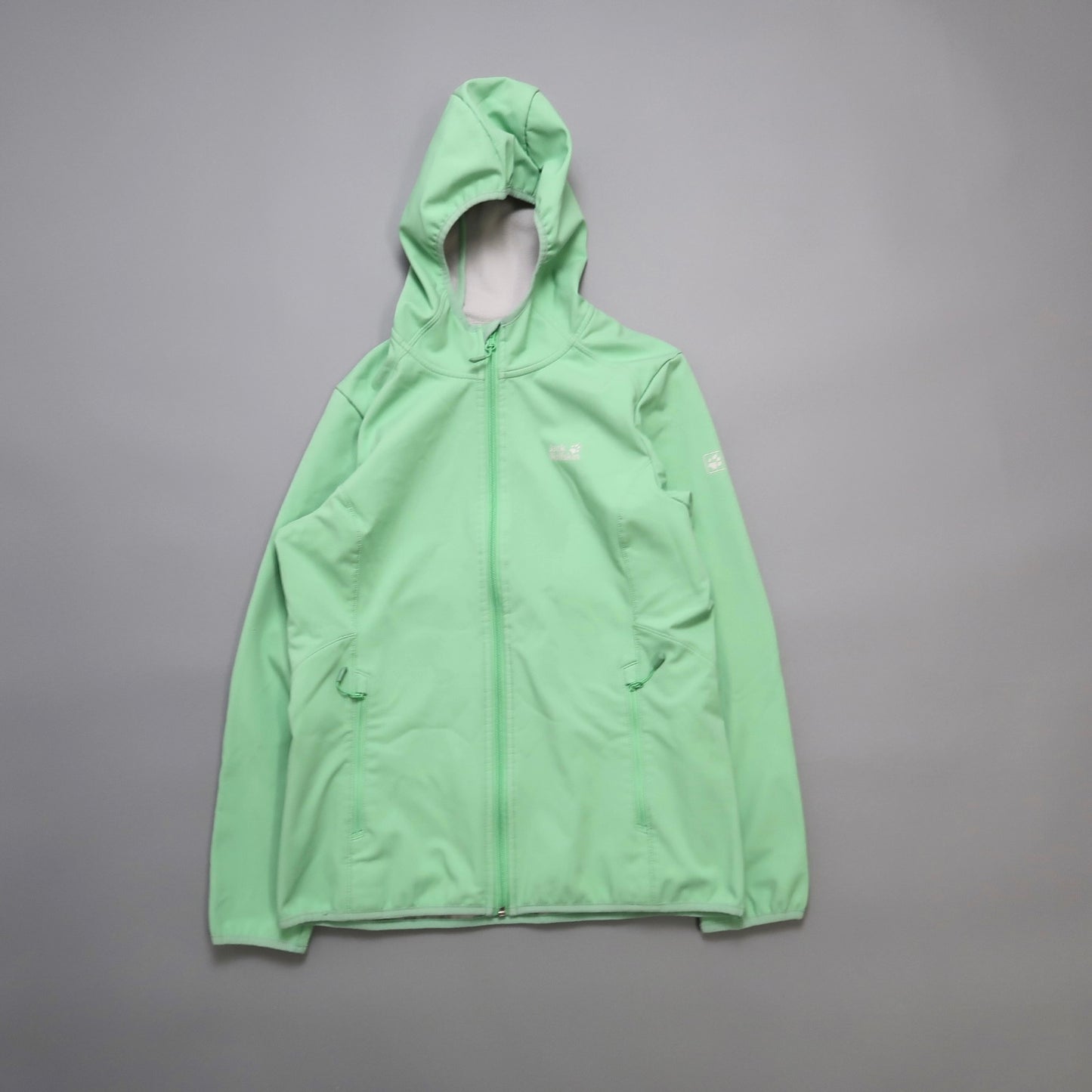 Green hooded jacket on a gray background.