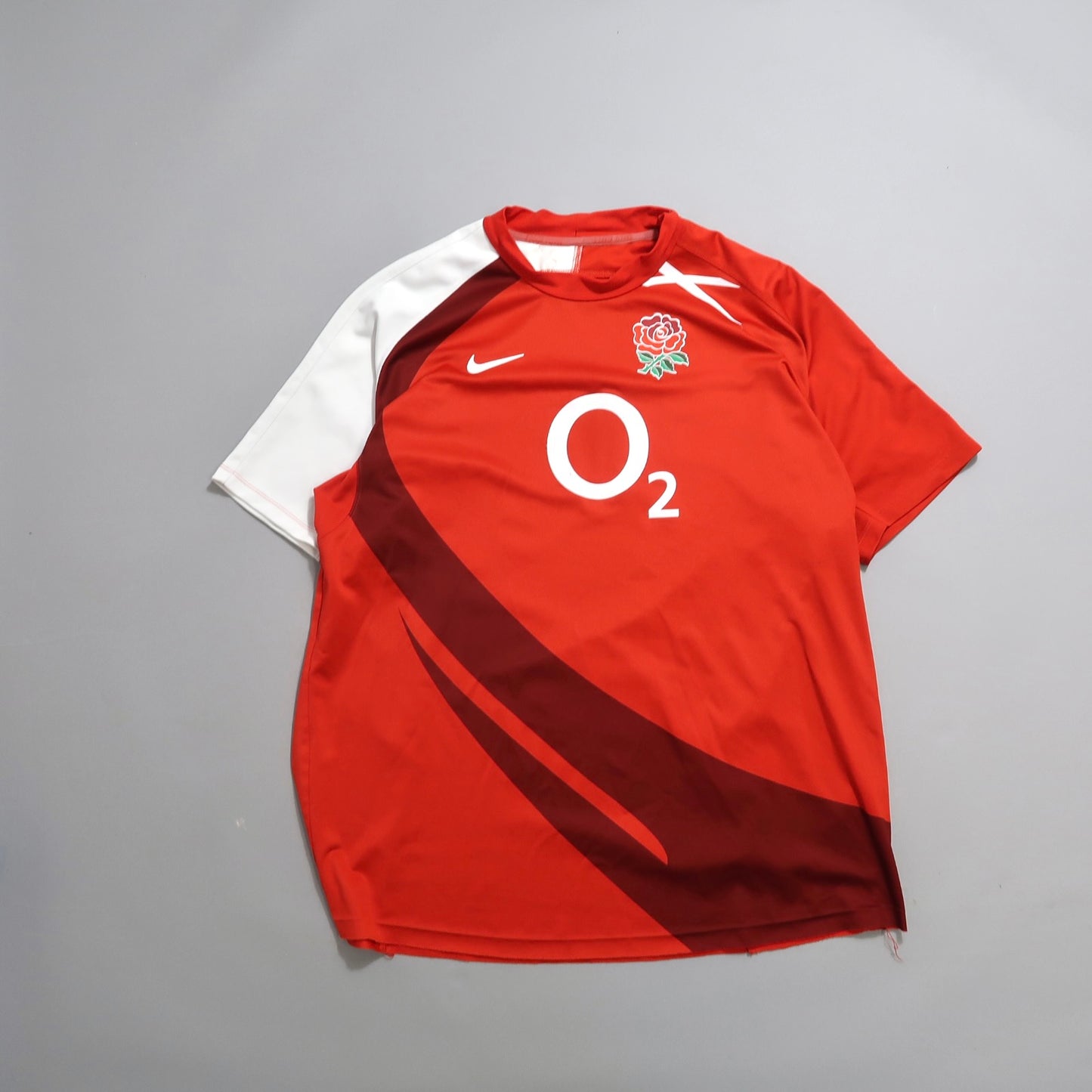 Red and white sports jersey with a rose emblem and nullO2null logo.