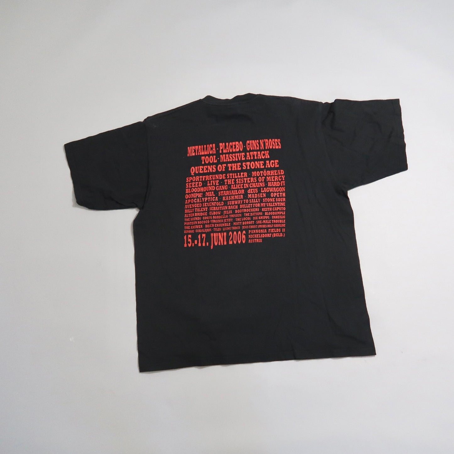 Black t-shirt with 2006 music festival lineup printed in red.