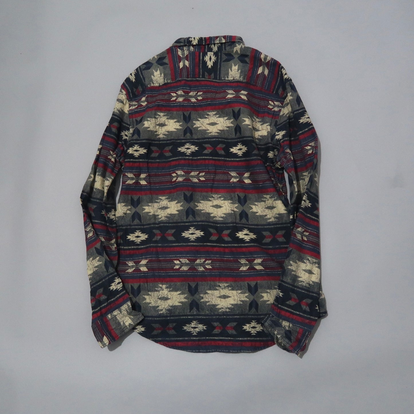 Patterned long-sleeve shirt with red, white, and blue geometric design.