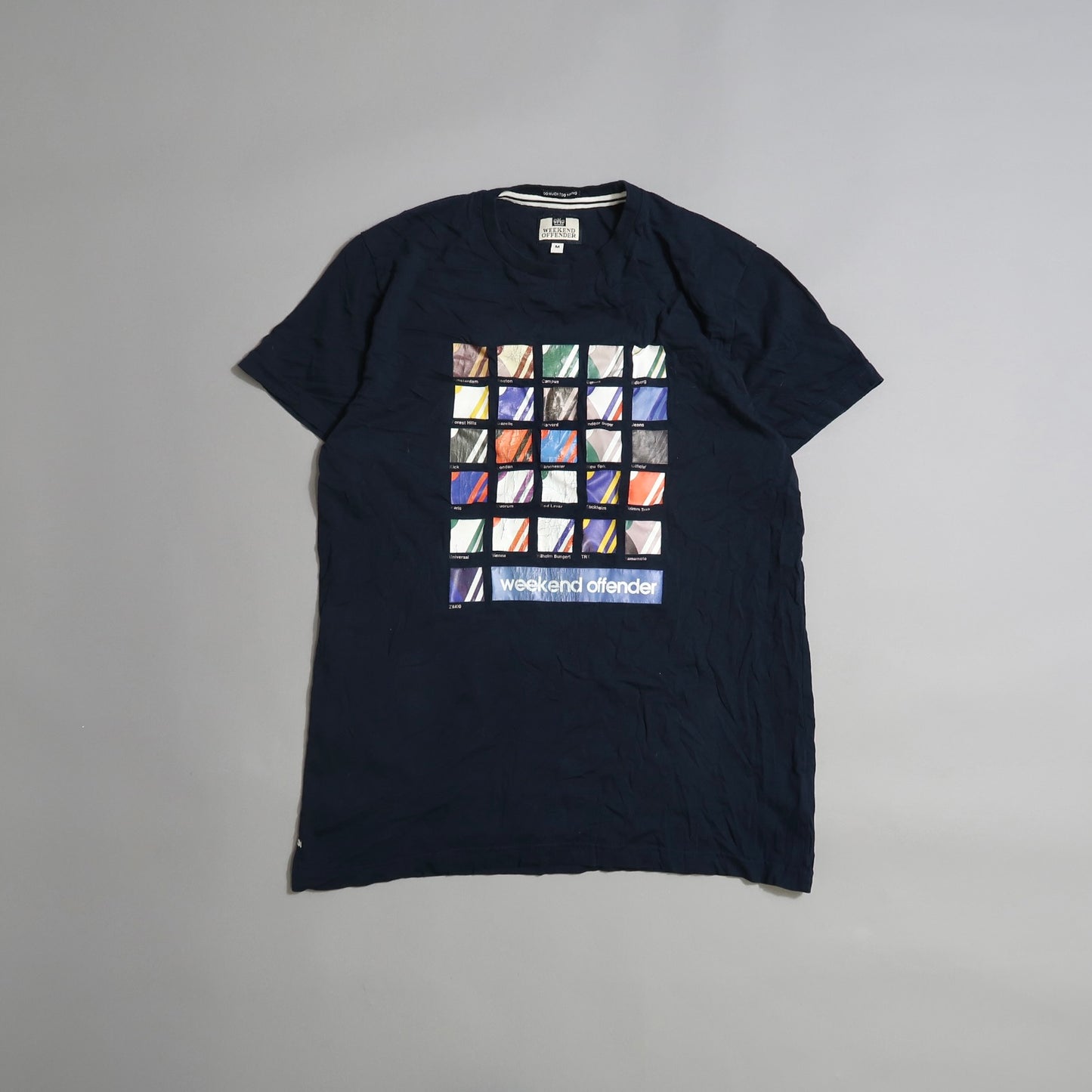 Navy T-shirt with colorful square design and nullweekend offendernull text.