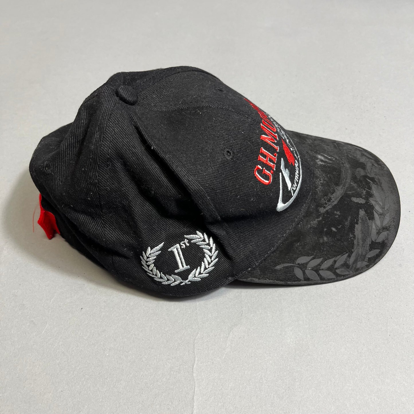Black cap with red and white embroidery, featuring null1stnull in laurel.