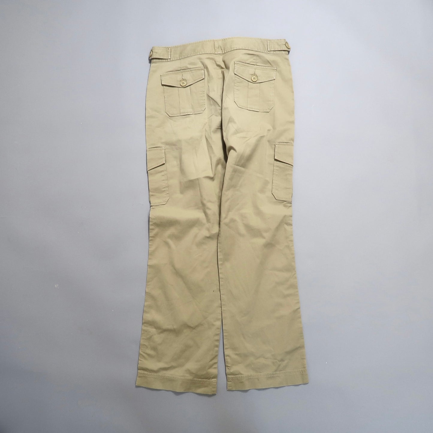 Khaki cargo pants with multiple pockets, viewed from the back.