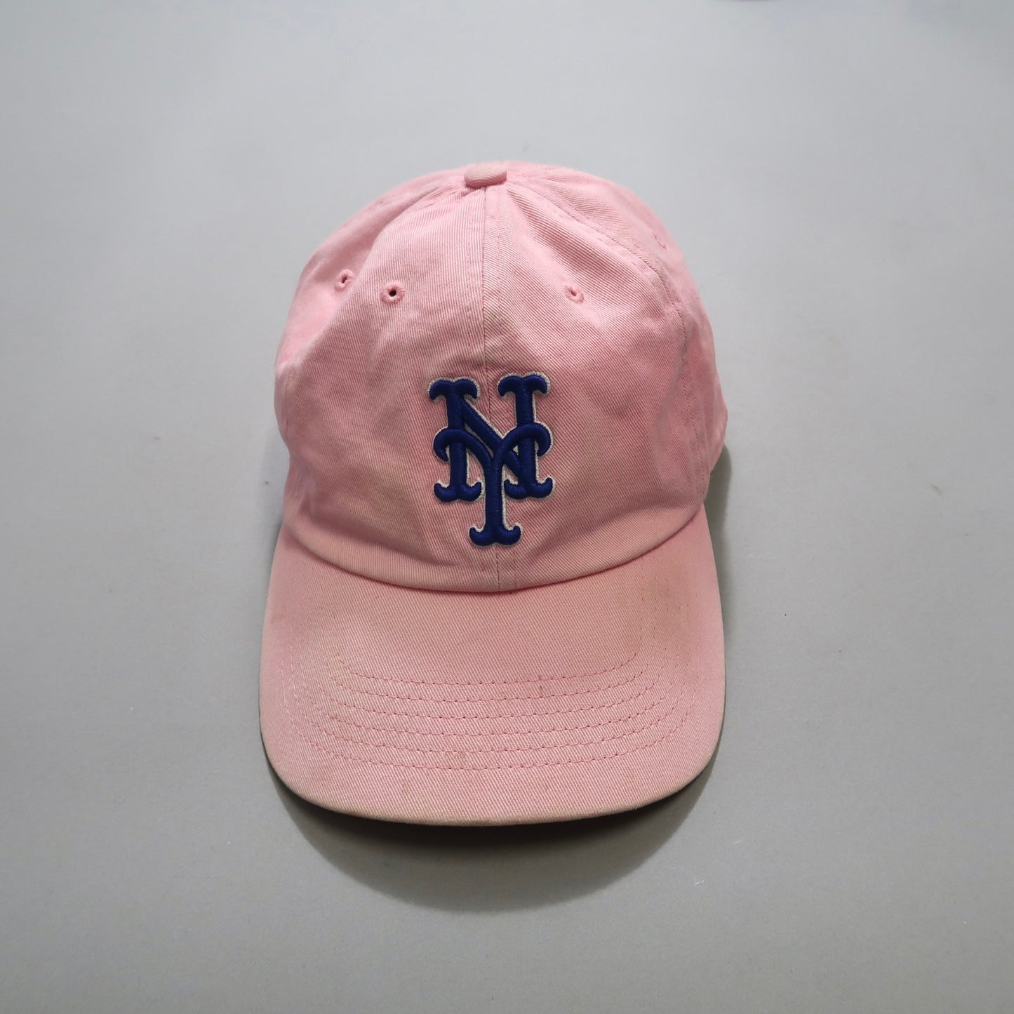 Pink baseball cap with a blue nullNYnull logo on the front.