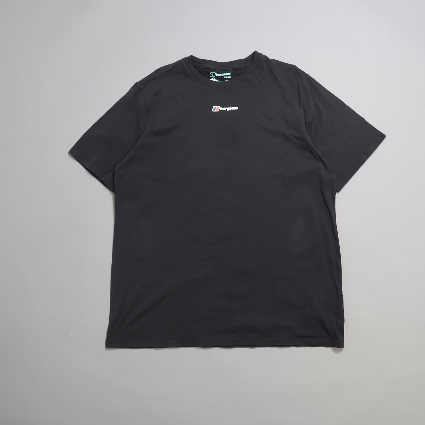Black t-shirt on a plain background with a small logo on the chest.