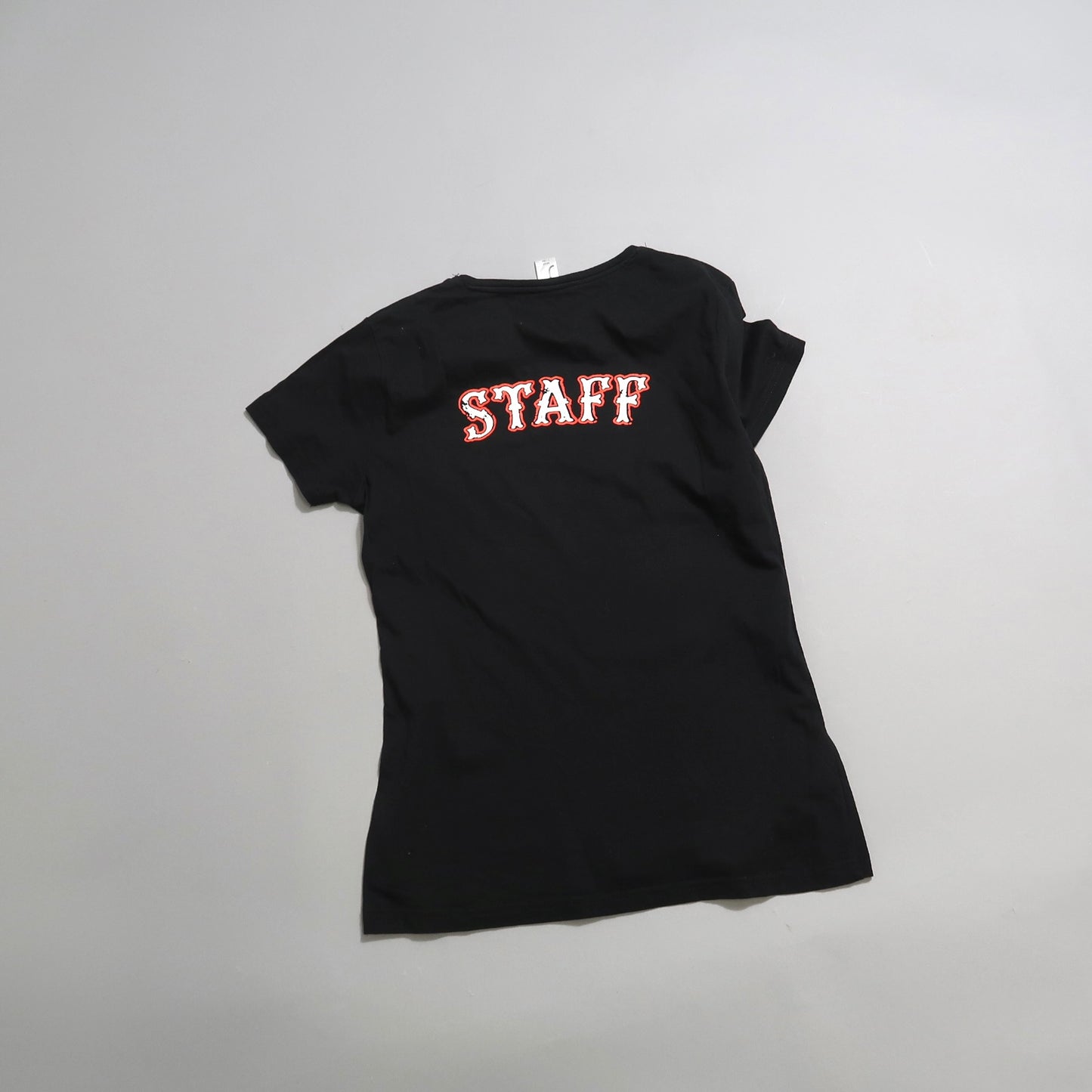 Black T-shirt with nullSTAFFnull text in red on the back.