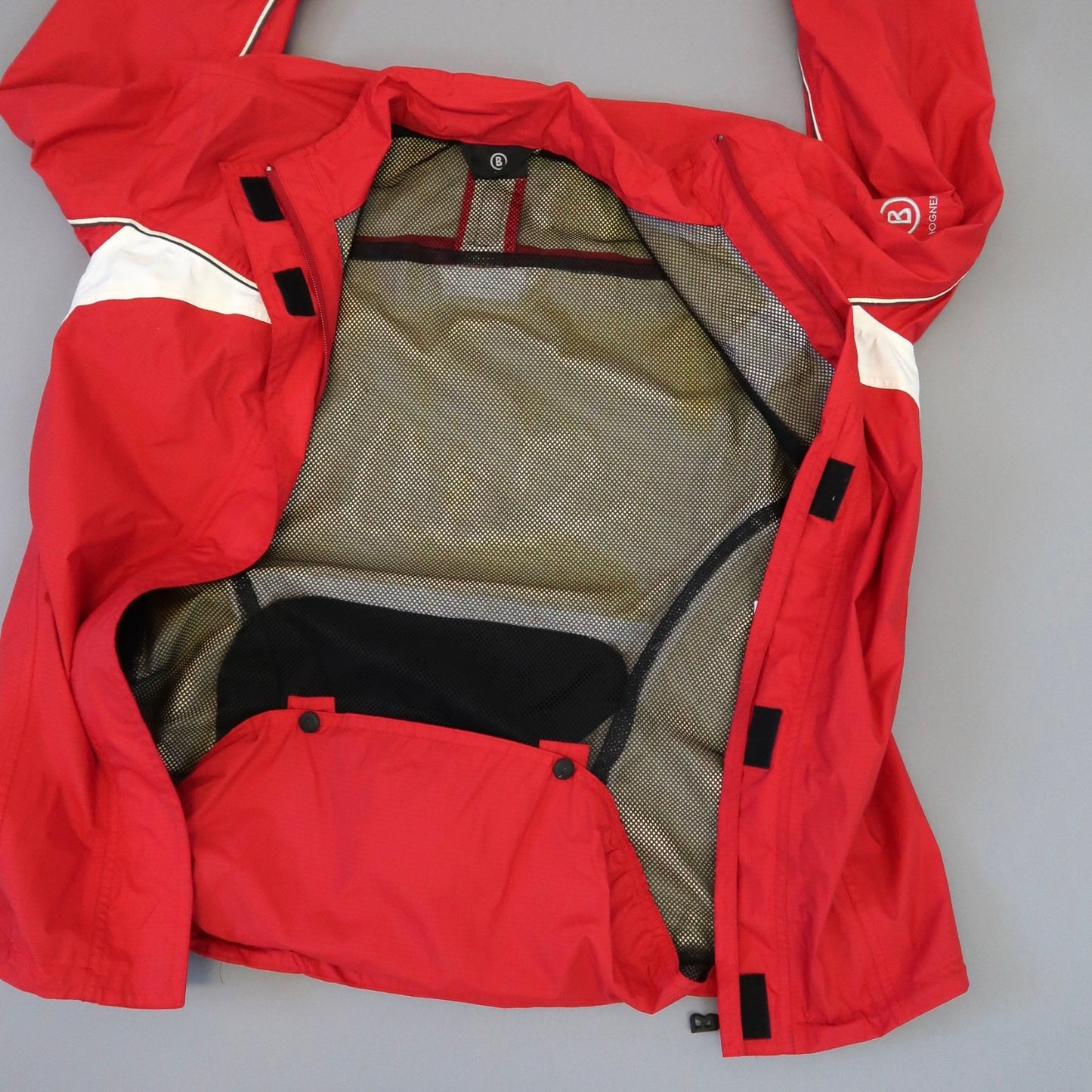 Red jacket with mesh lining and white accents on the sleeves.