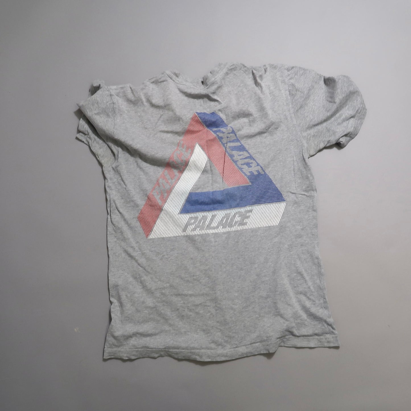Gray T-shirt with multicolored geometric triangle design.