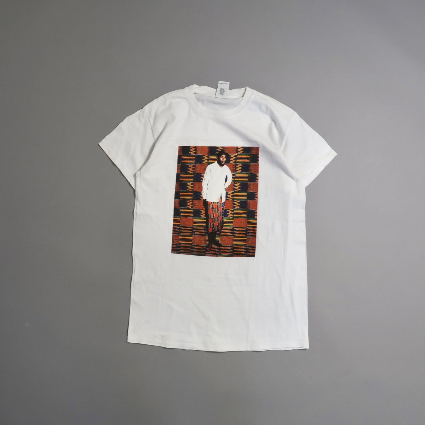 White T-shirt with a colorful patterned photo print.