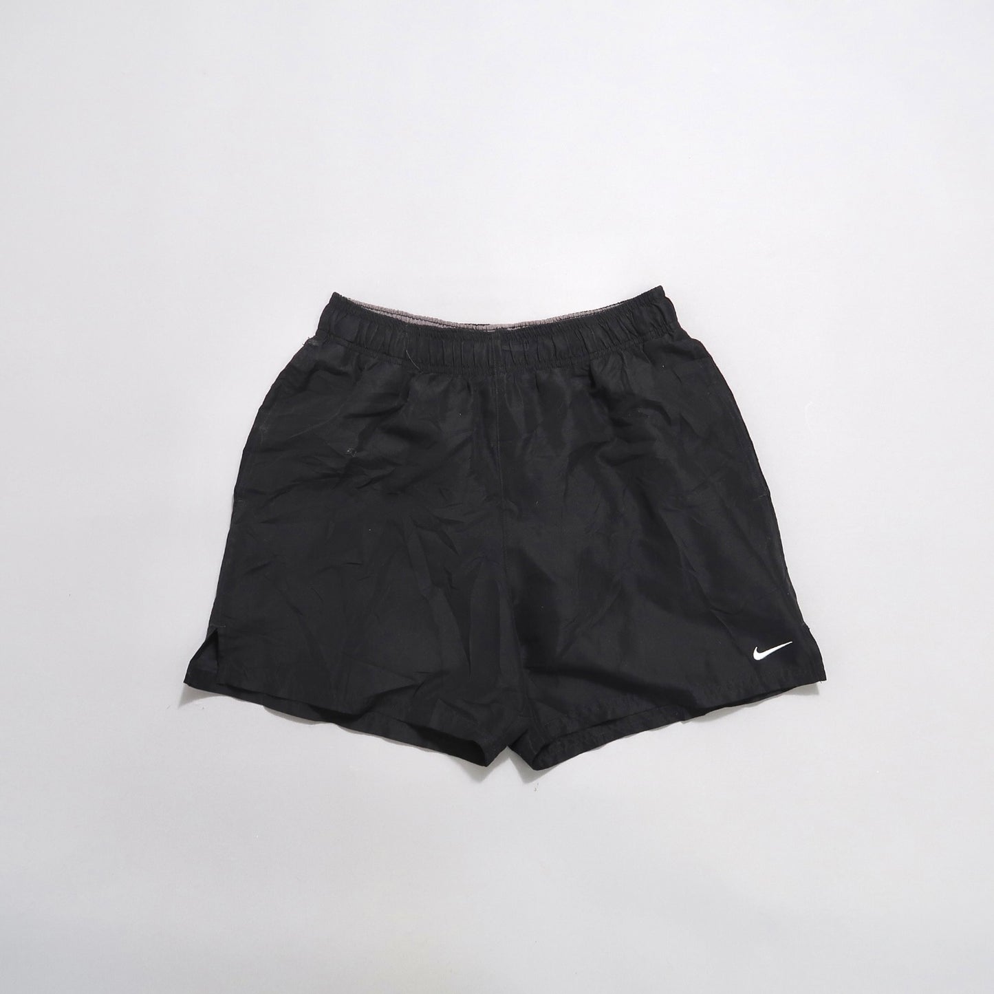 Black athletic shorts with a small white logo on the front.
