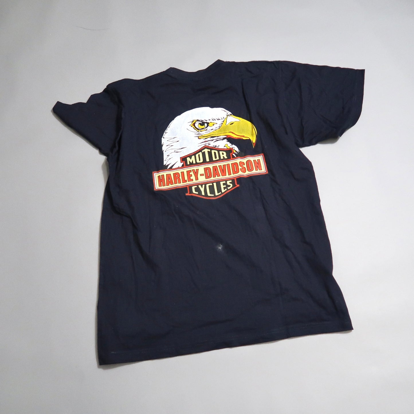 Navy T-shirt with a Harley-Davidson eagle logo on the back.