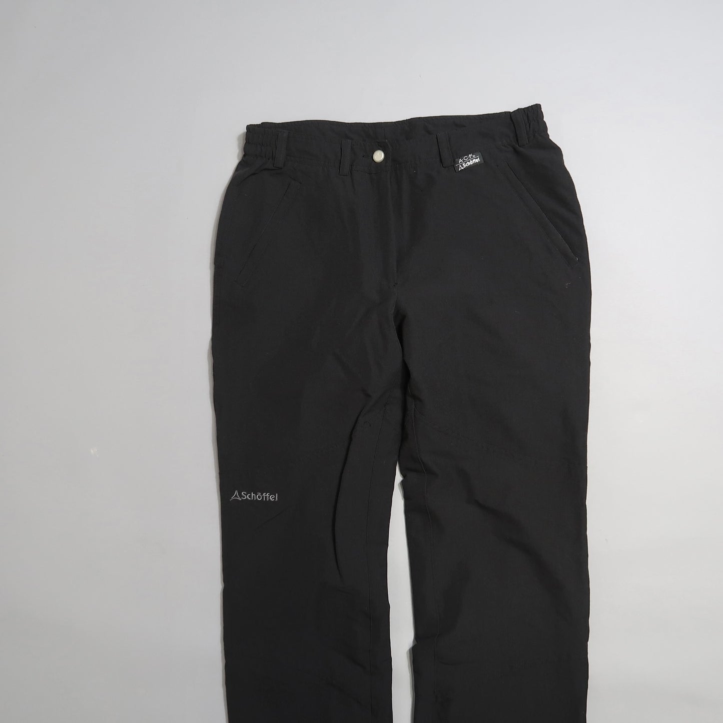 Black Schöffel pants on a light gray background.