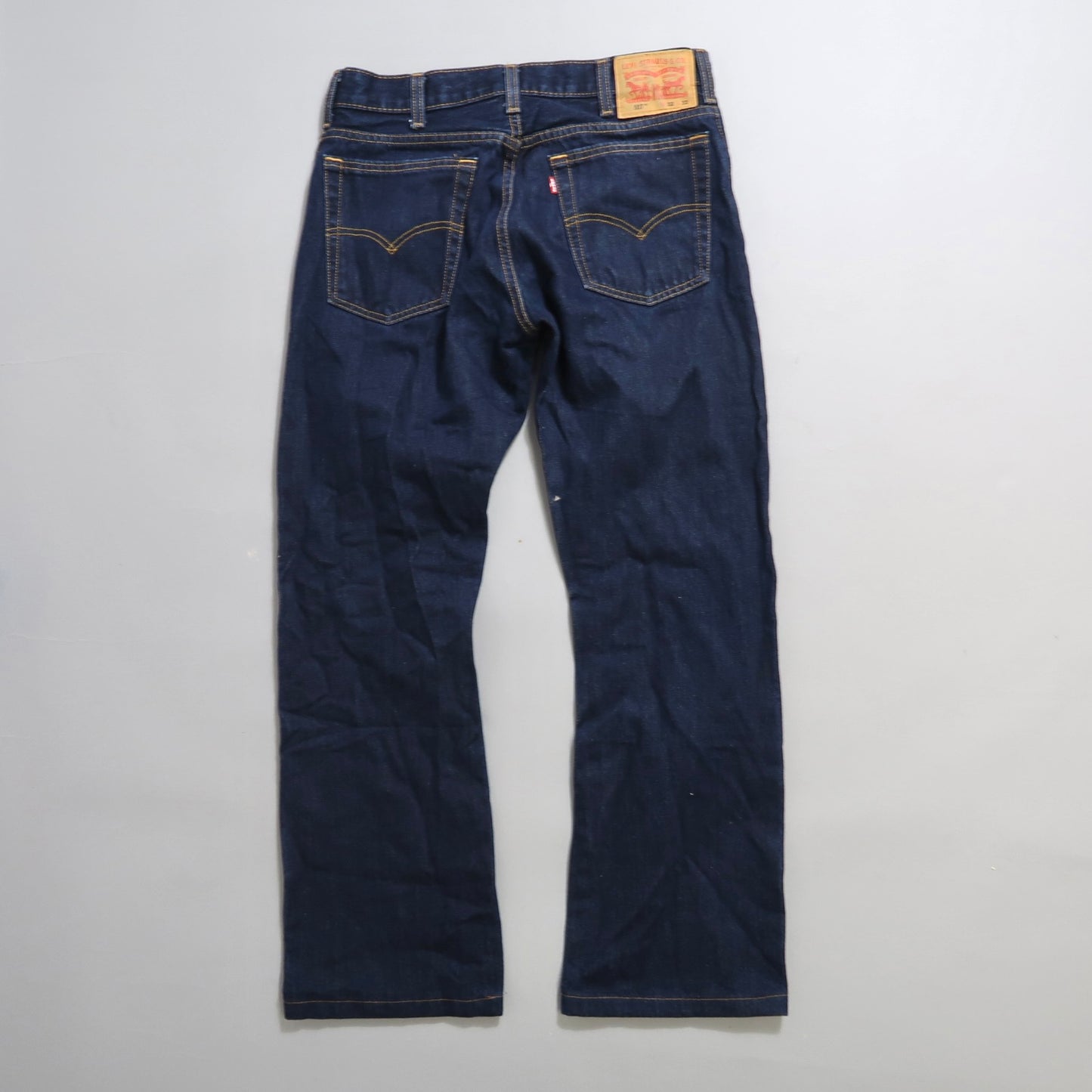 Dark blue jeans with back pockets and a leather patch.