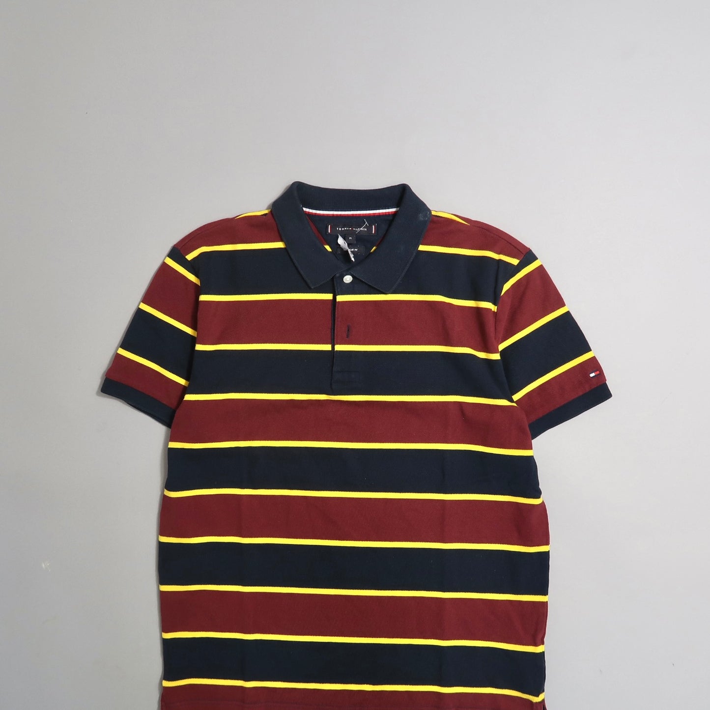 Striped navy and burgundy polo shirt with yellow lines.