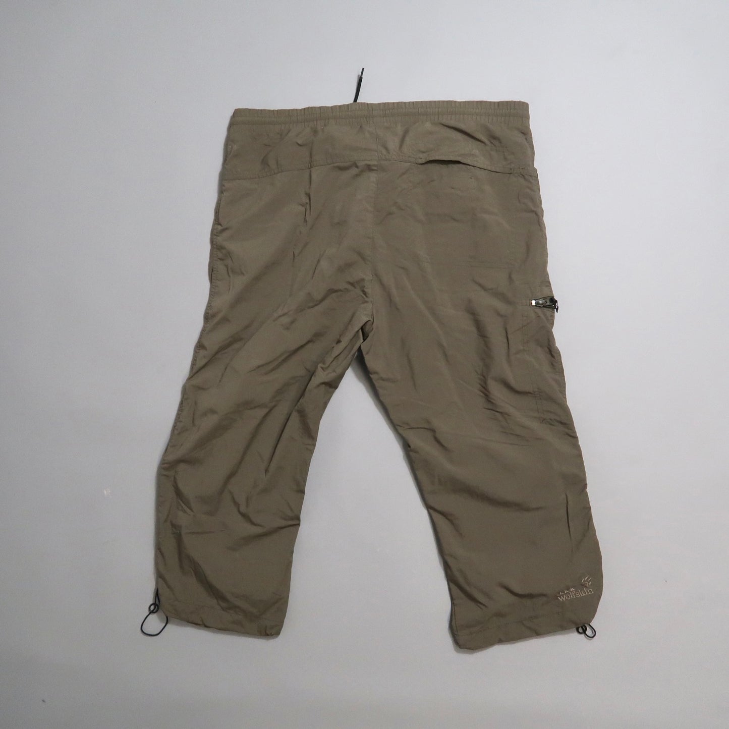 Khaki capri pants laid flat on a white background.