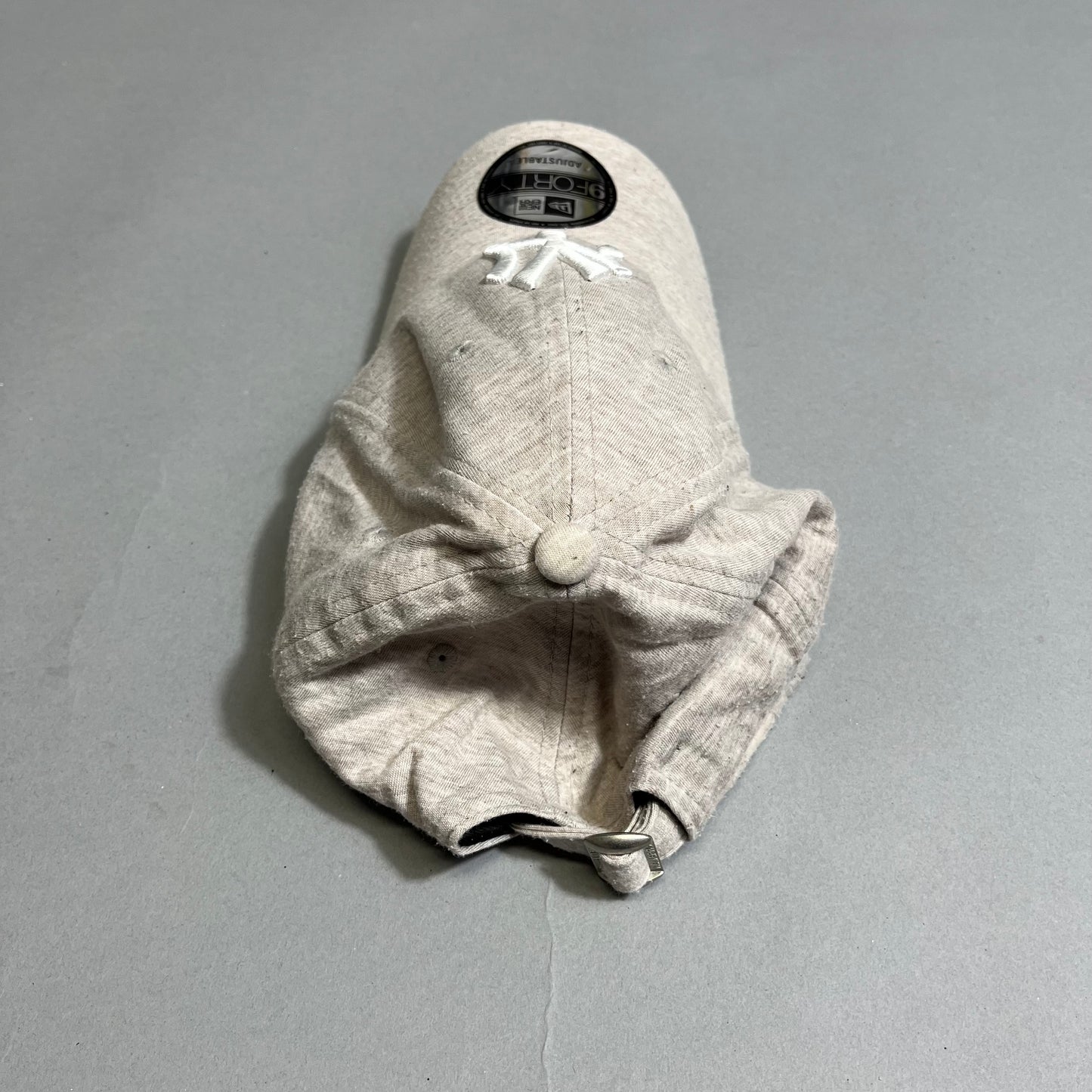 Gray baseball cap with a New York logo, laid flat.