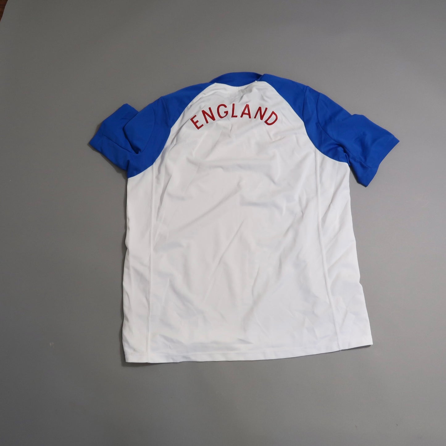 White and blue England sports jersey, back view.