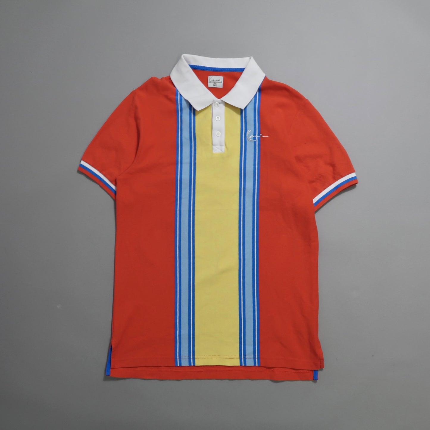 Red polo shirt with yellow and blue stripes, white collar.
