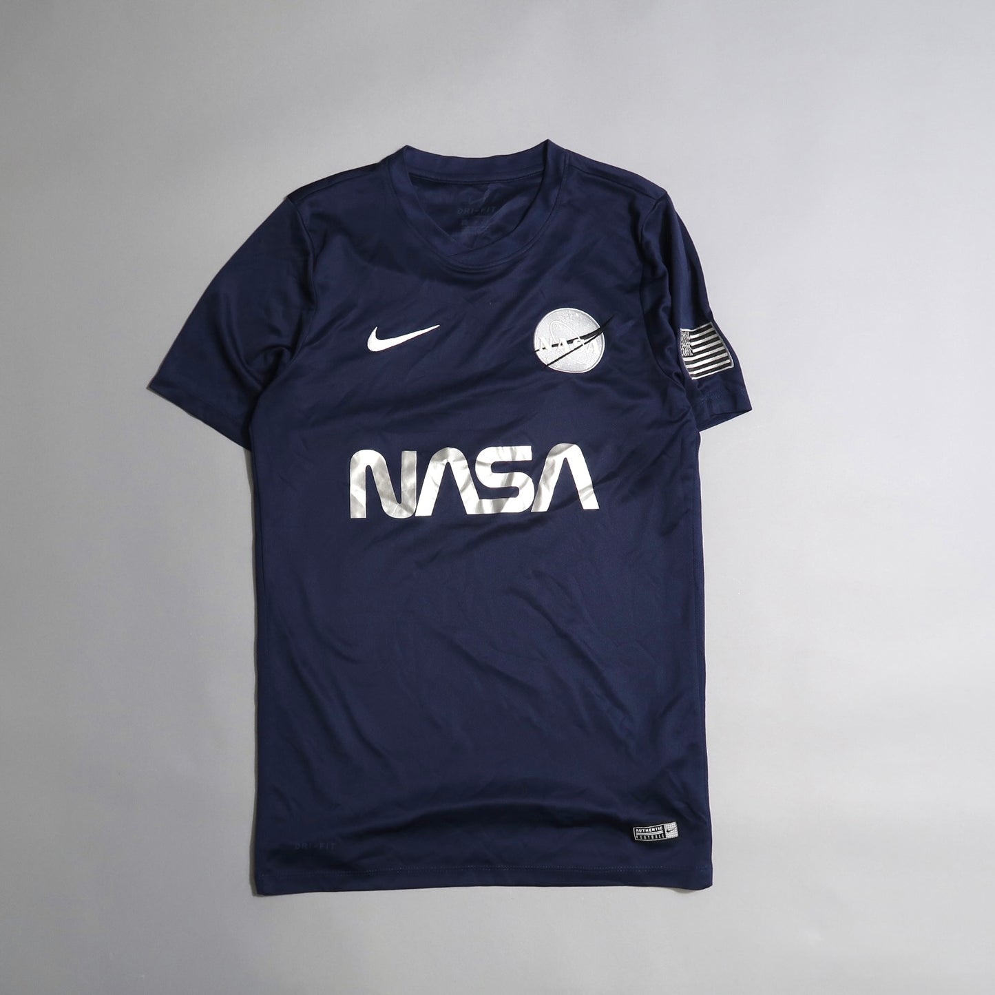 Navy blue NASA t-shirt with Nike logo and patch on sleeve.