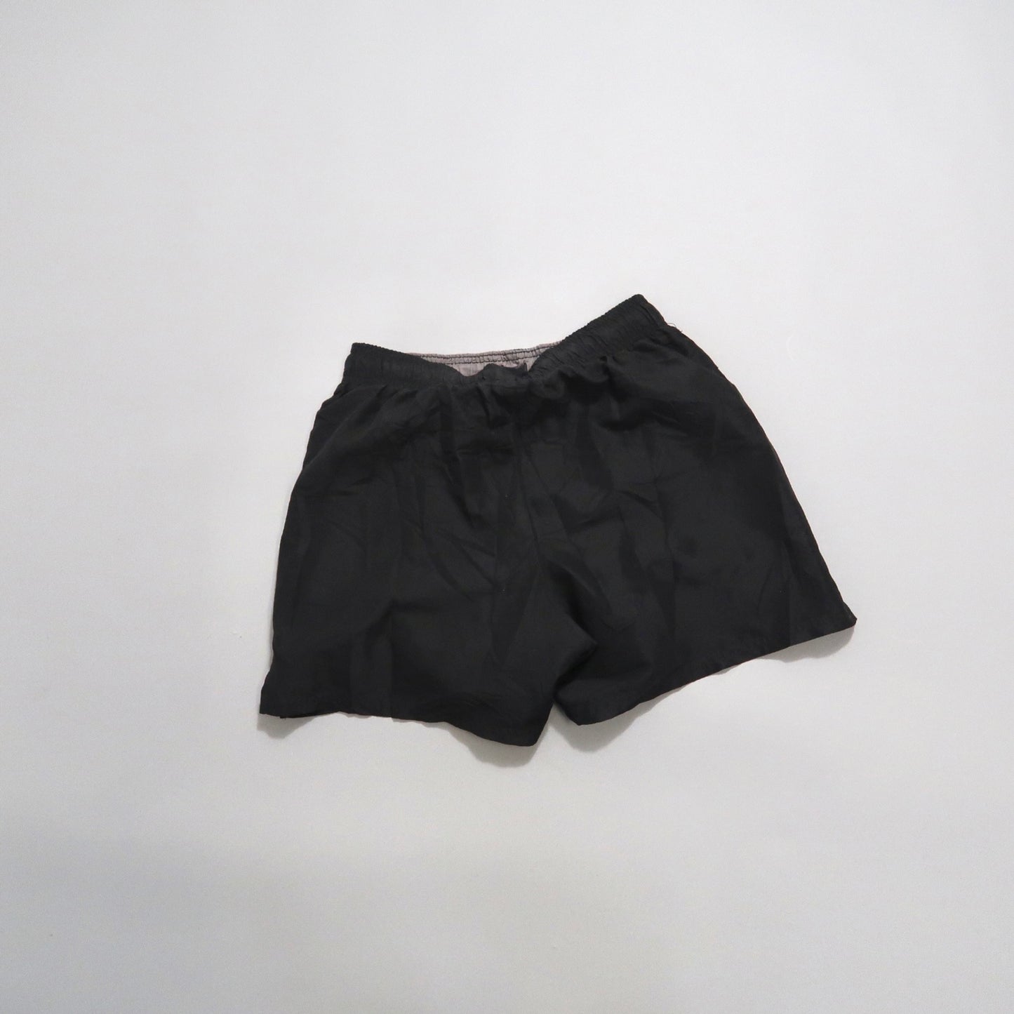 Black athletic shorts on a plain white background.