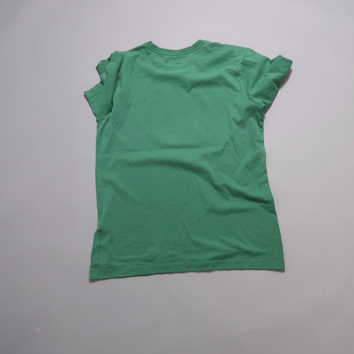Green T-shirt displayed on a gray background, back view.