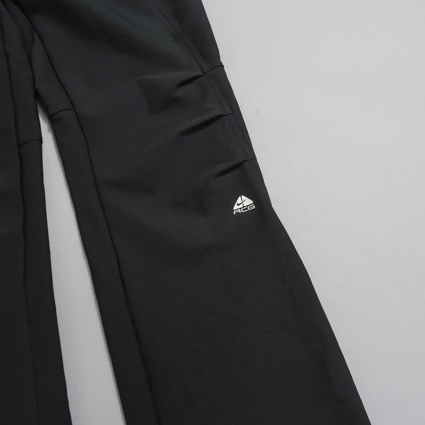Black pants with ACG logo on a light gray background.