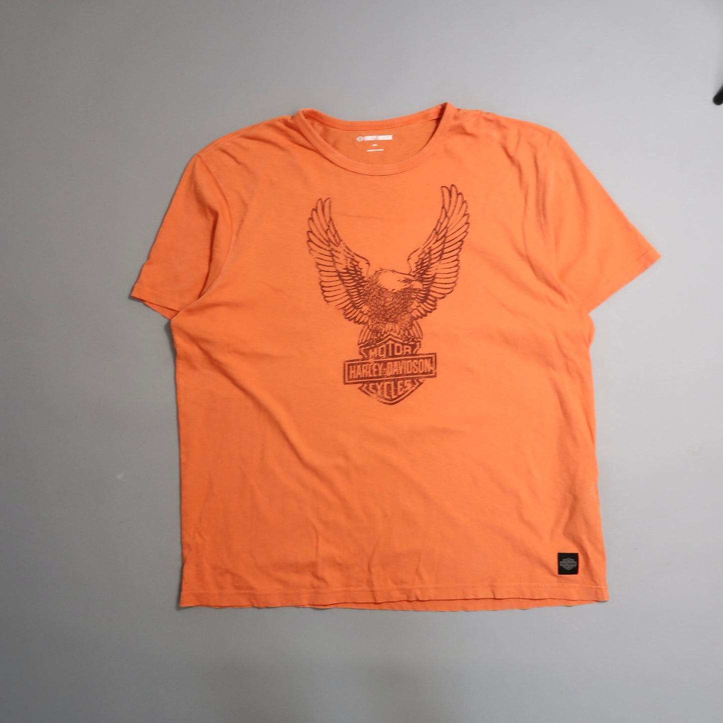 Orange T-shirt with eagle and Harley-Davidson logo design.