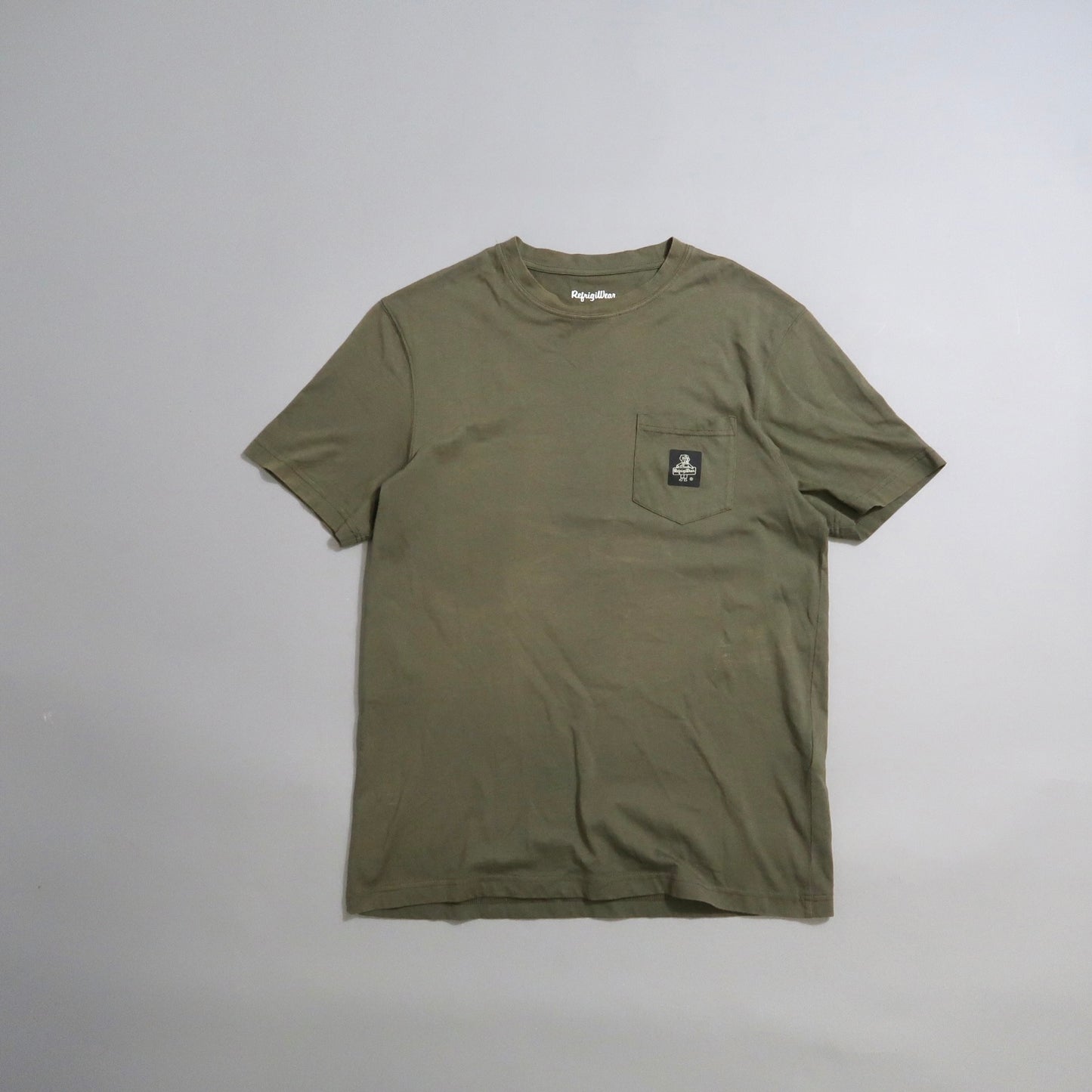 Olive green t-shirt with a chest pocket and small logo.