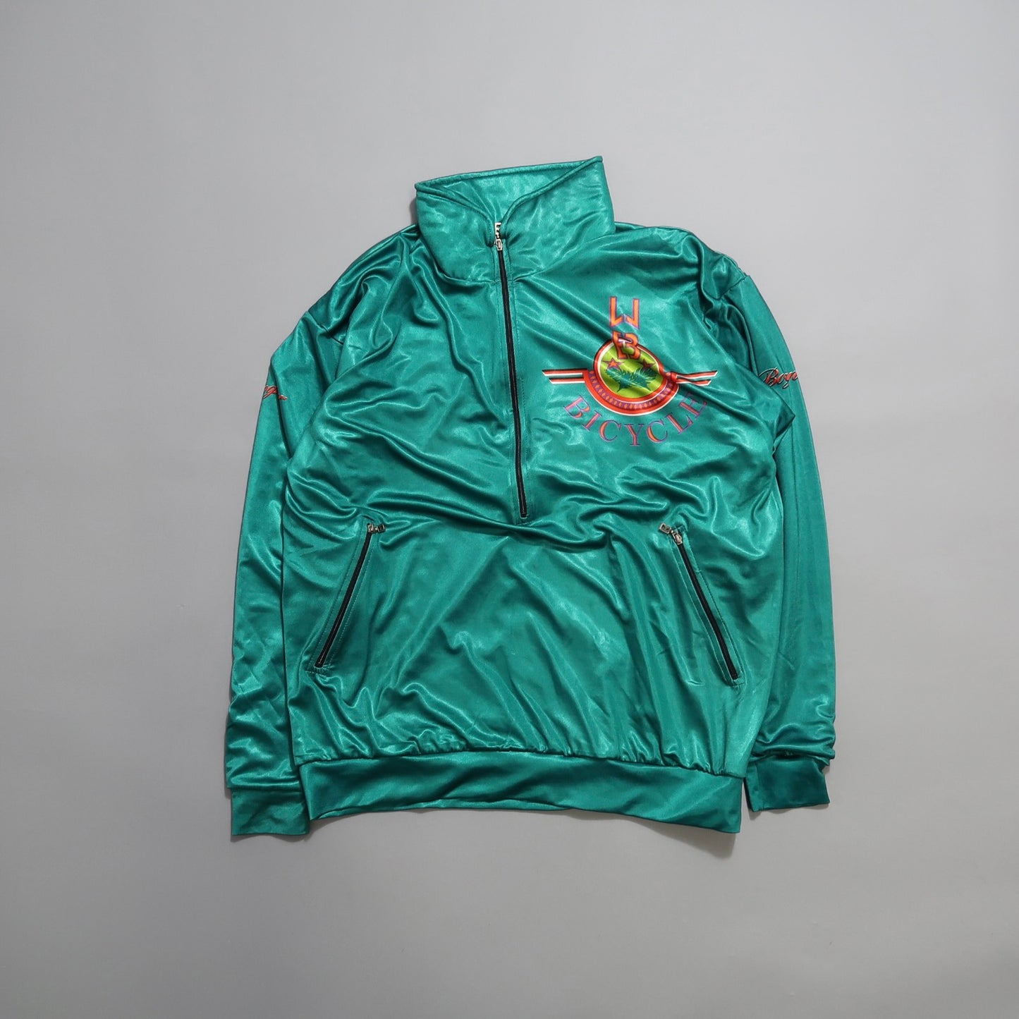 Green zip-up jacket with bicycle club logo and chest embroidery.