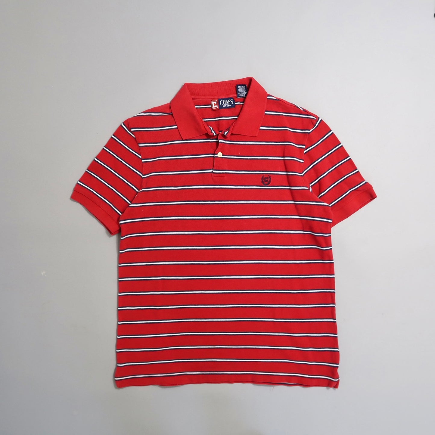 Red striped polo shirt on a plain gray background.