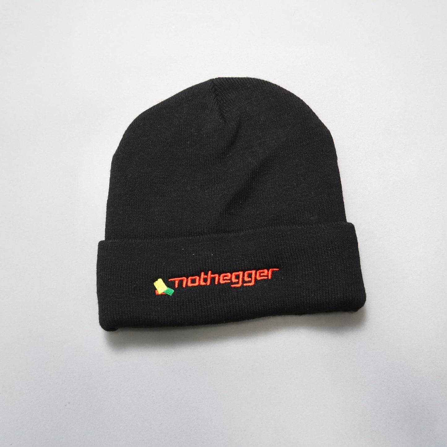 Black beanie with nullnotheggernull logo embroidered on the cuff.