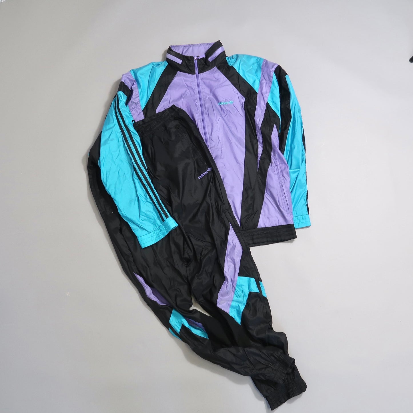 Vintage track suit with purple, teal, and black color blocks.