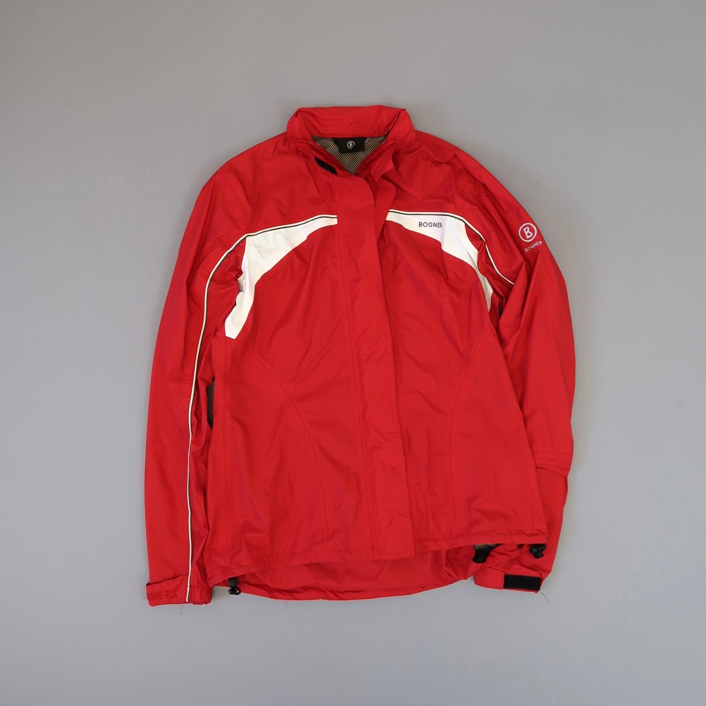 Red jacket with white accents on a neutral background.