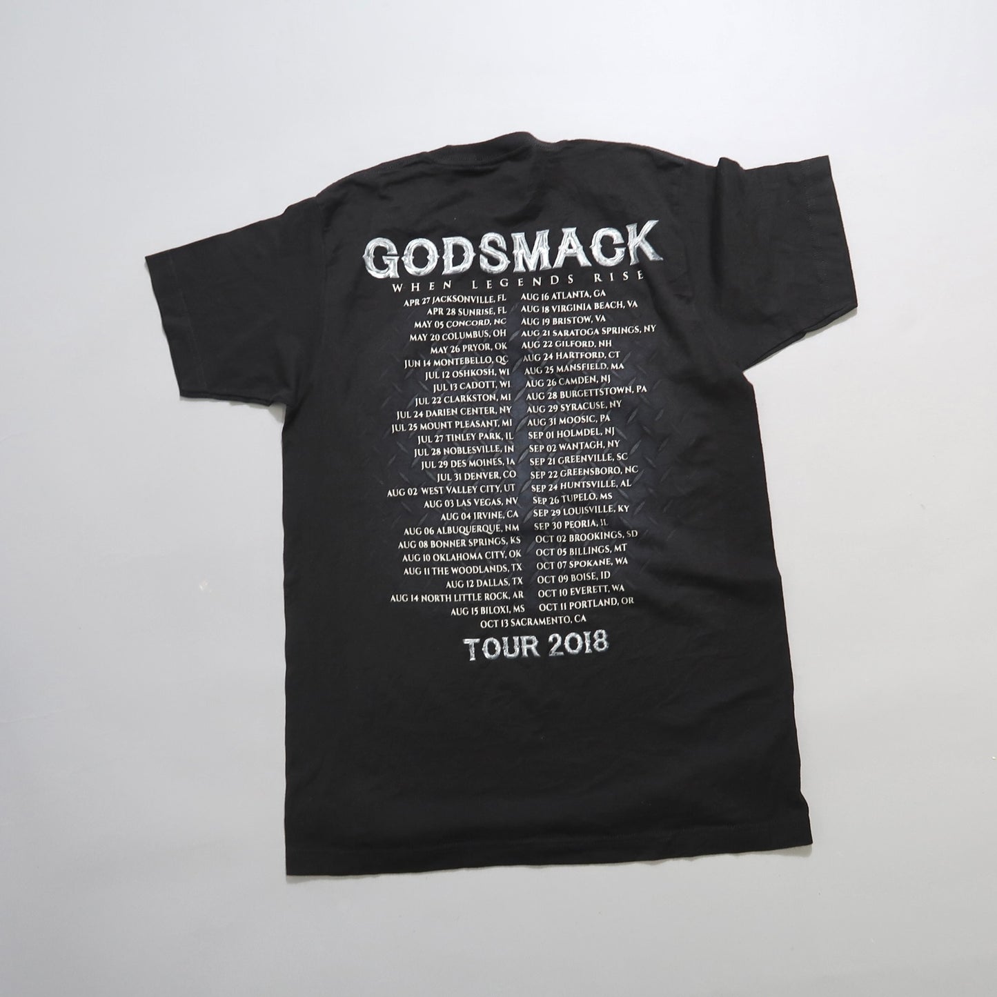 Black Godsmack 2018 tour T-shirt with concert cities listed on the back.