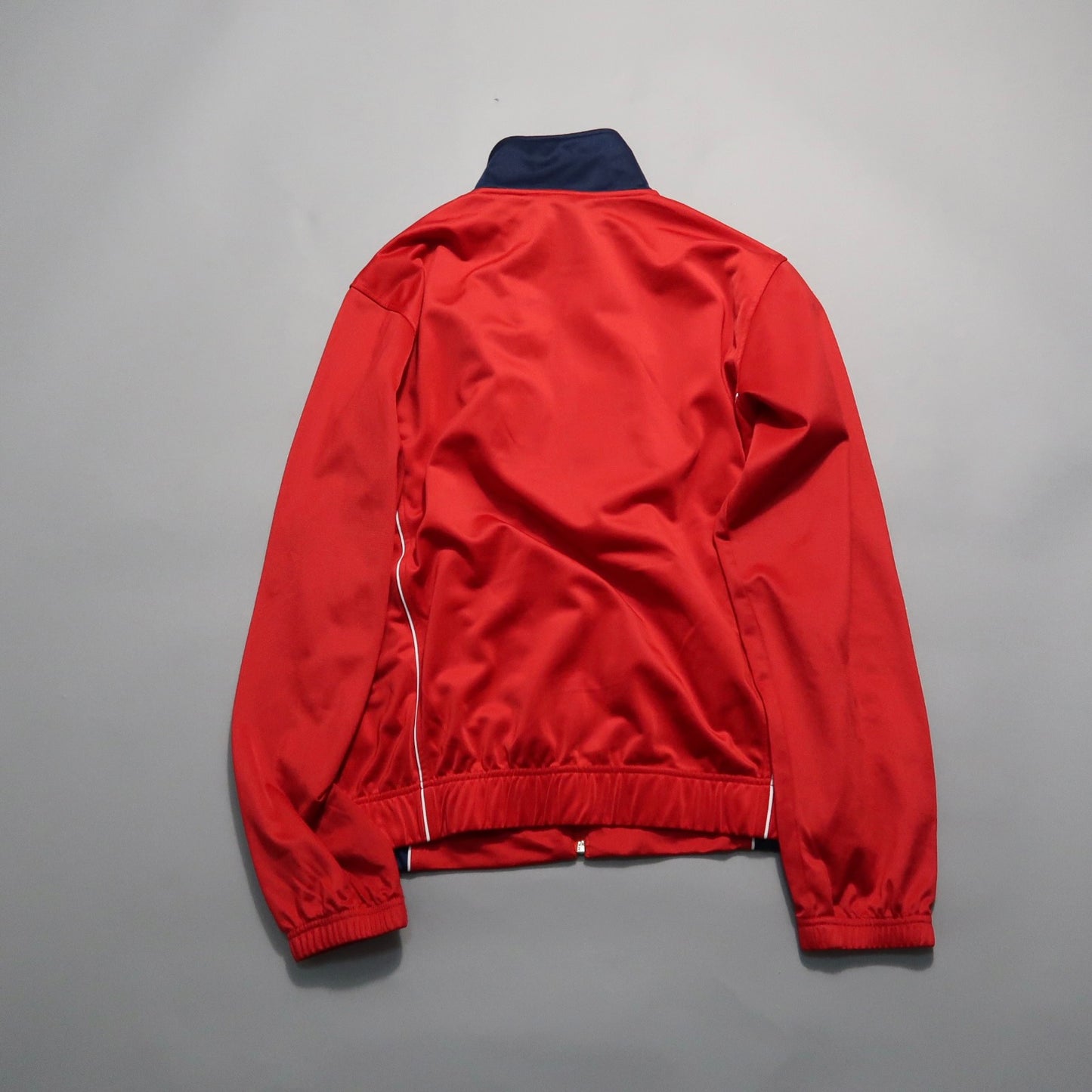 Red jacket with a blue collar, back view on a gray background.
