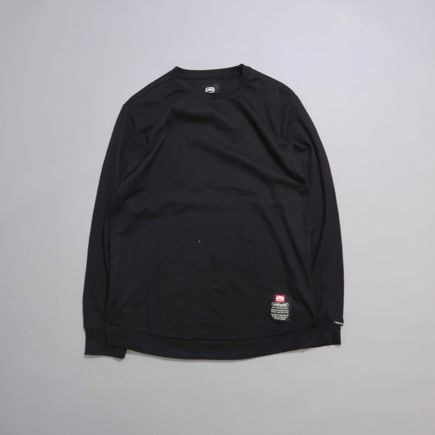 Black long-sleeve shirt on a plain gray background.