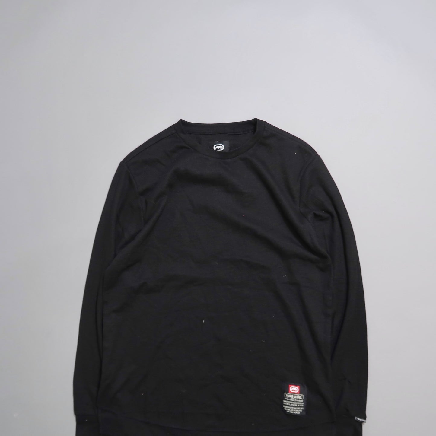 Black long-sleeve shirt on a gray background.
