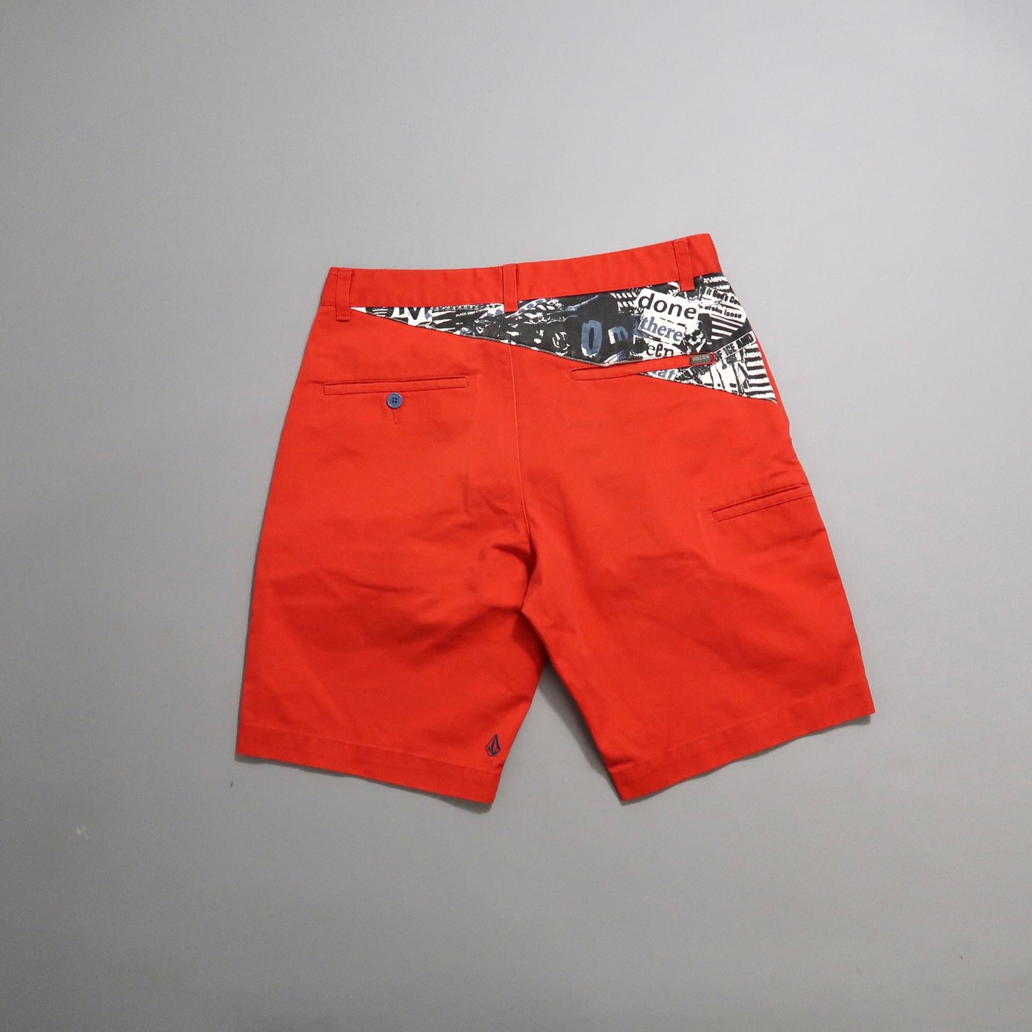 Red shorts with patterned waistband and back pockets.