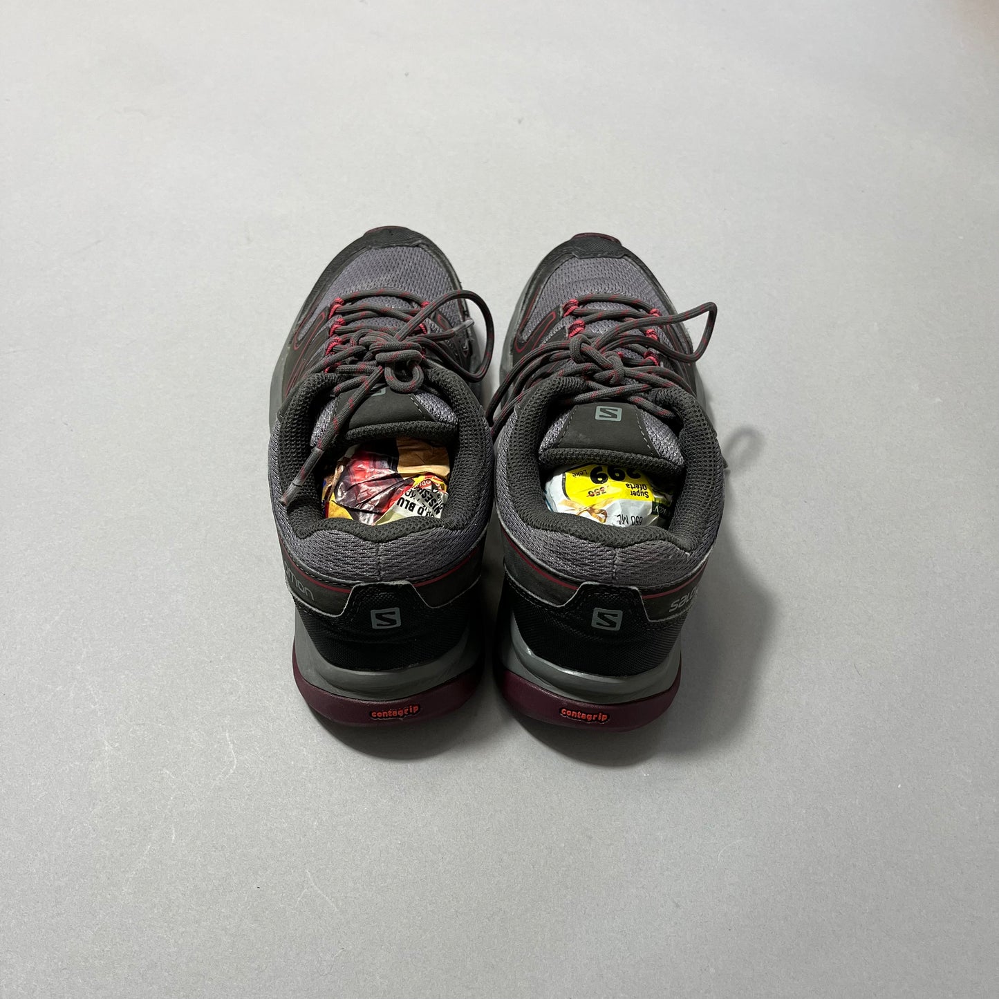 Gray sneakers with fruit labels inside, viewed from the back.