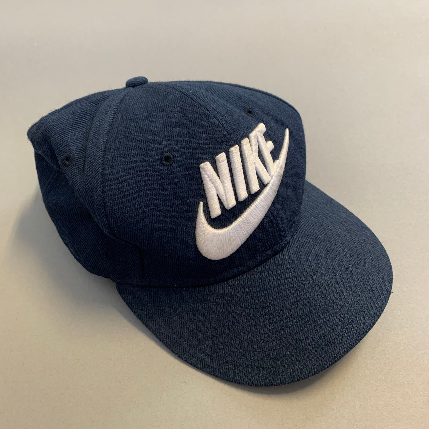 Navy blue Nike cap with logo on the front.