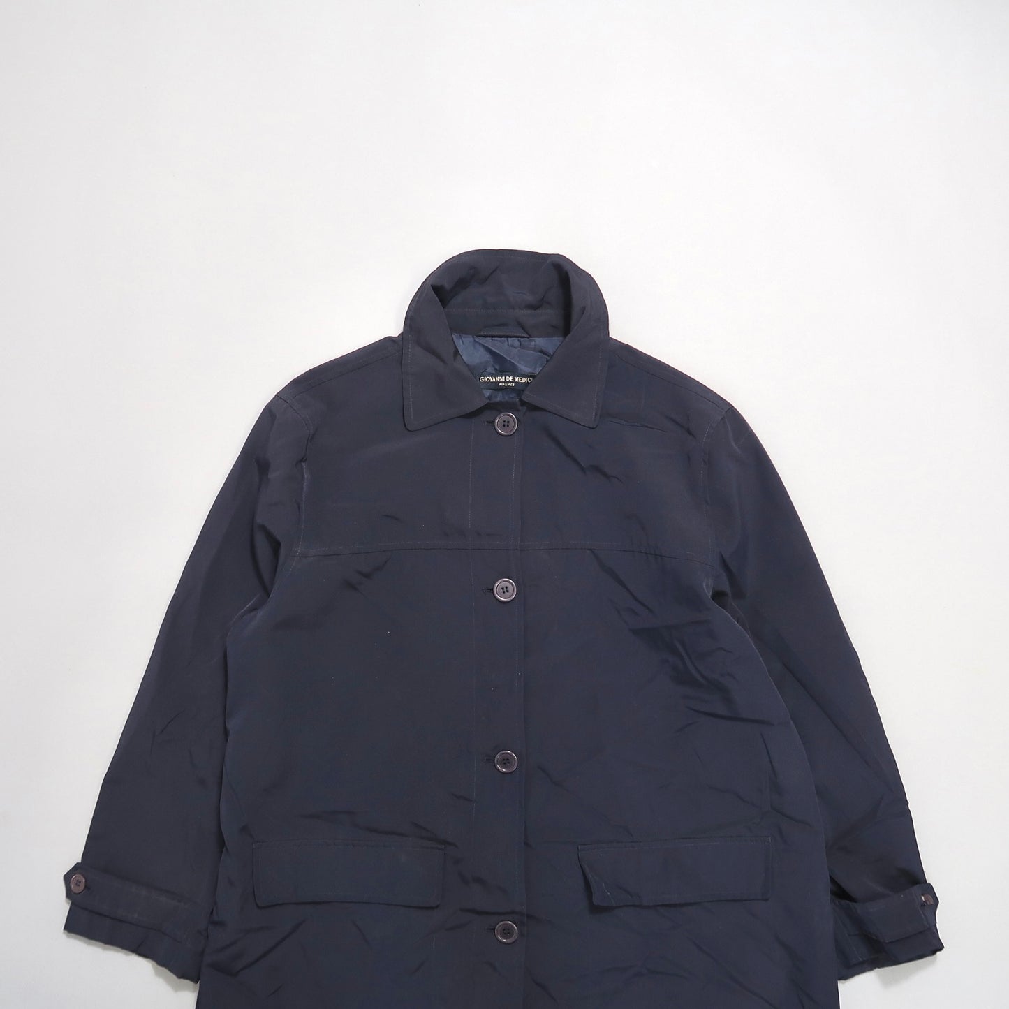 Dark navy button-up coat with collar and pockets.
