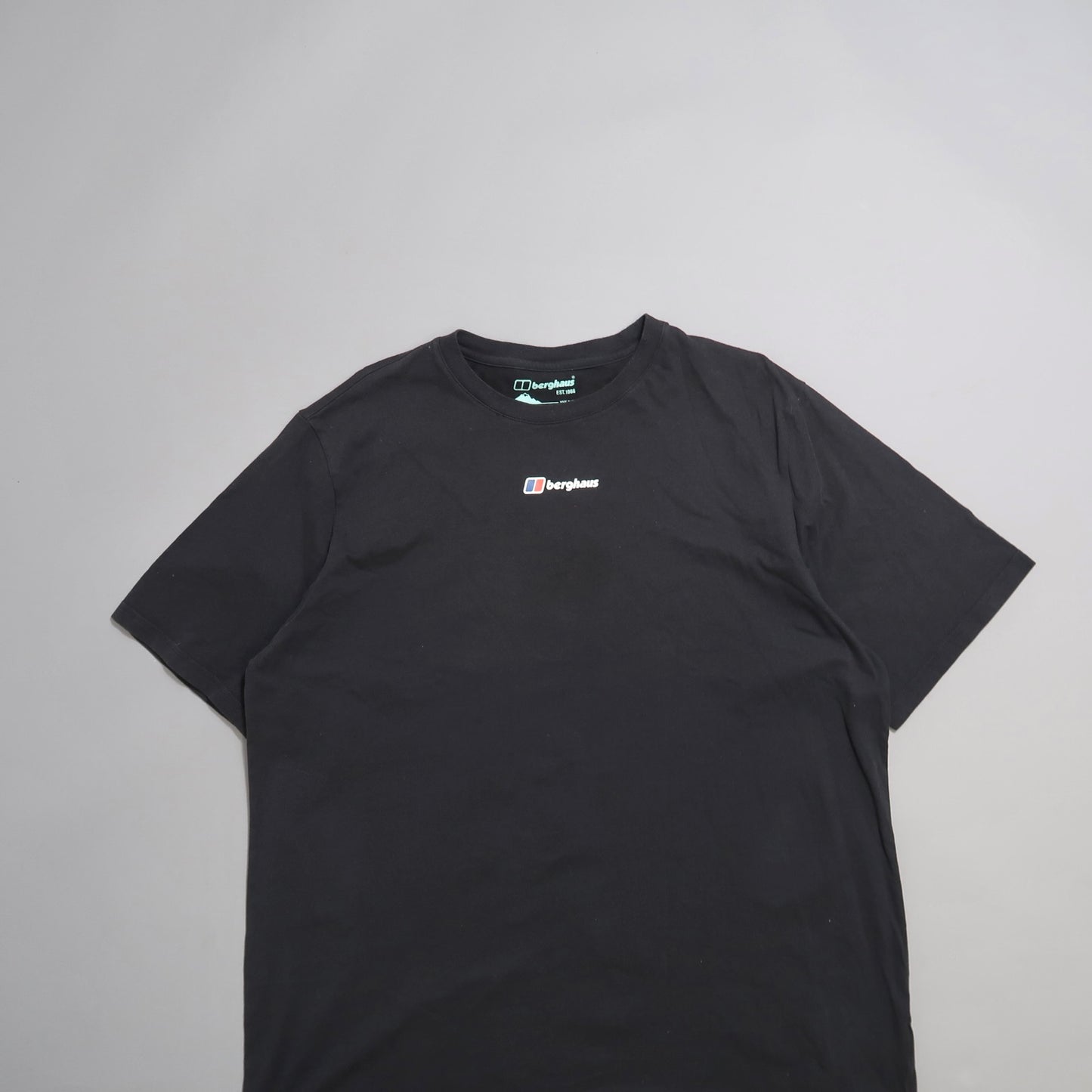 Black T-shirt with a small nullberghausnull logo on the front.