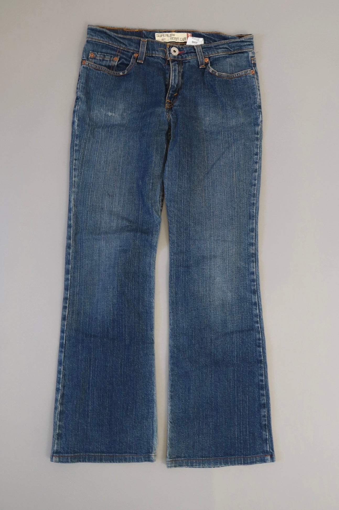 Blue flared jeans on a plain background.