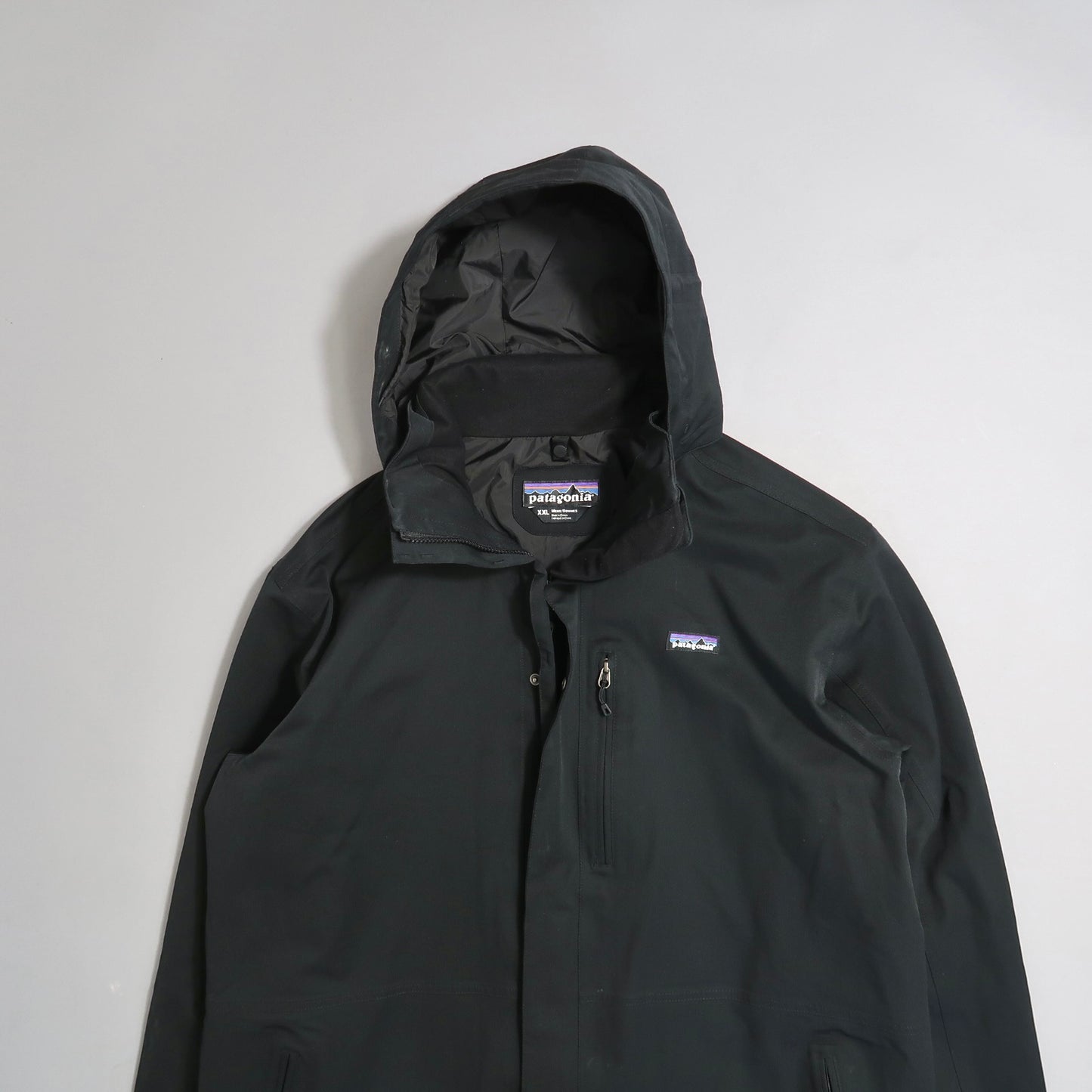 Black hooded jacket with a small logo on the front.