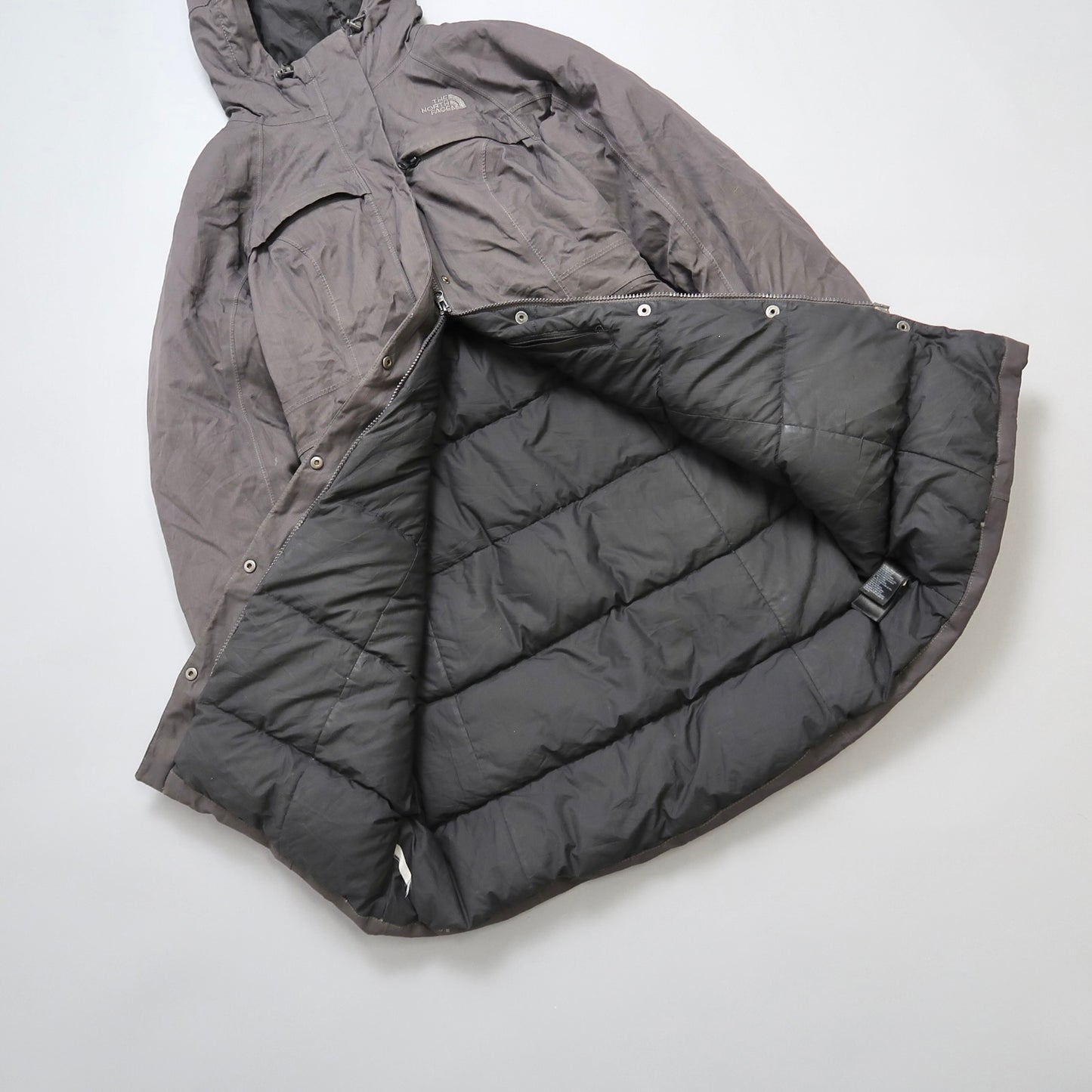 Gray hooded jacket with a quilted lining, displayed open.