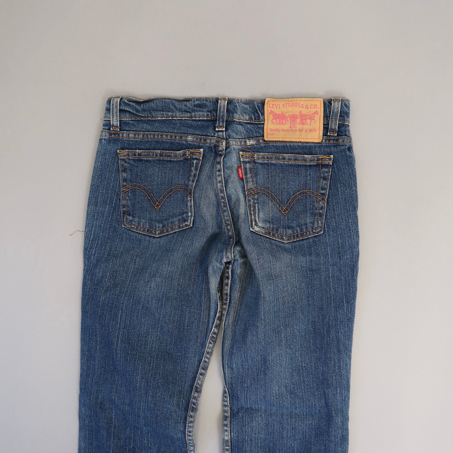 Back view of blue jeans with visible label and pockets.